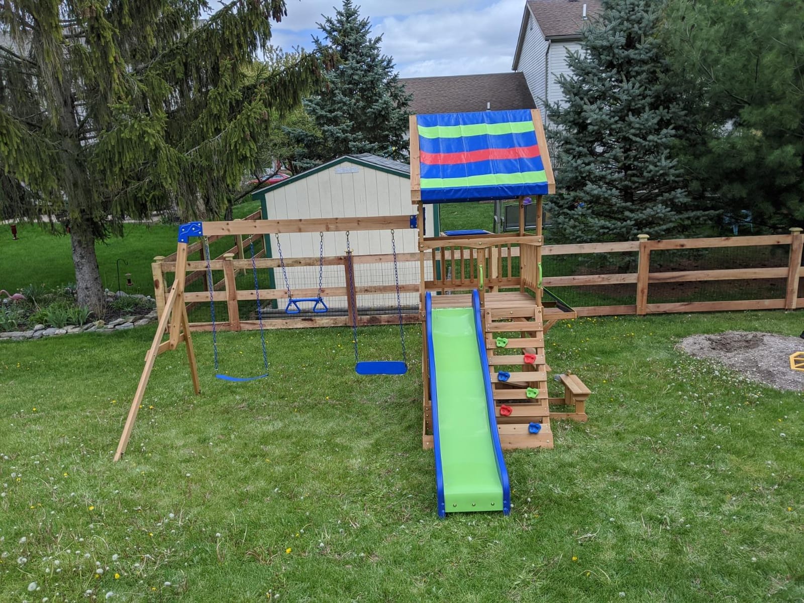 Backyard Discovery Beach Front Cedar Wood Swing Set with Wave Slide, Play Deck, Monkey Bars, Rock Wall Ladder, Shaded Picnic Area, Snack Bar, Belt Swings, Trapeze, Sandbox Area, Outdoor Playset customer photo 1